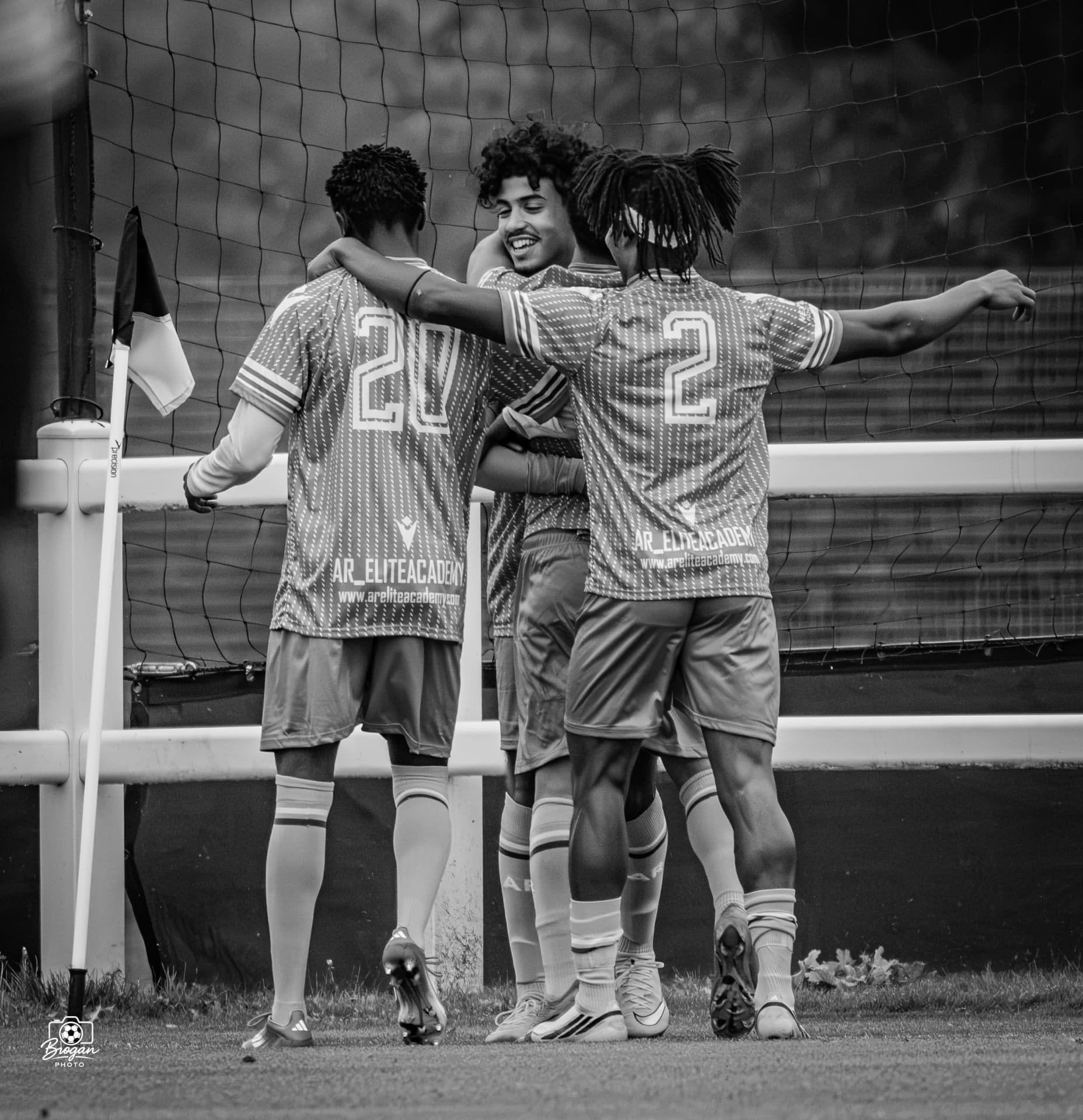 AR Elite players celebrating together in black and white